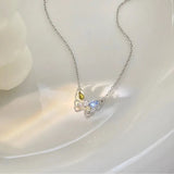 Butterfly-shaped necklace with gemstones on a white background
