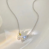 Butterfly-shaped necklace with gemstones on a white background