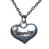 Silver heart-shaped pendant with 'Sevenity' engraving on a chain against a glittery white background