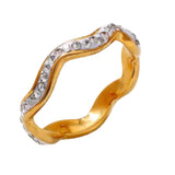 Gold ring with diamond accents on a light gray background