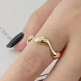 Hand wearing Serenity wave rings