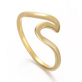 Gold  Serenity Ring™  with a wavy design on a white background