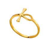 Gold ring with a ankh cross design on a white surface.