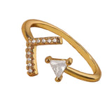 Gold ring with a triangle-shaped gemstone on a white background